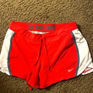 Pink and white women Nike running shorts